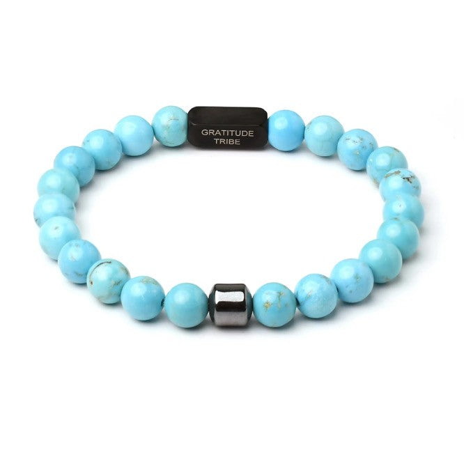 Turquoise beaded bracelet with a black tag on a white background, blue, black, front.