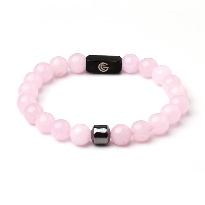 Pink beaded bracelet with black accents on a white background, pink, black, front.