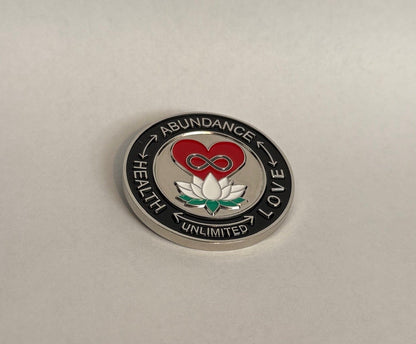 Circular emblem with a heart, lotus flower, and text on a beige background, coin, back, black.